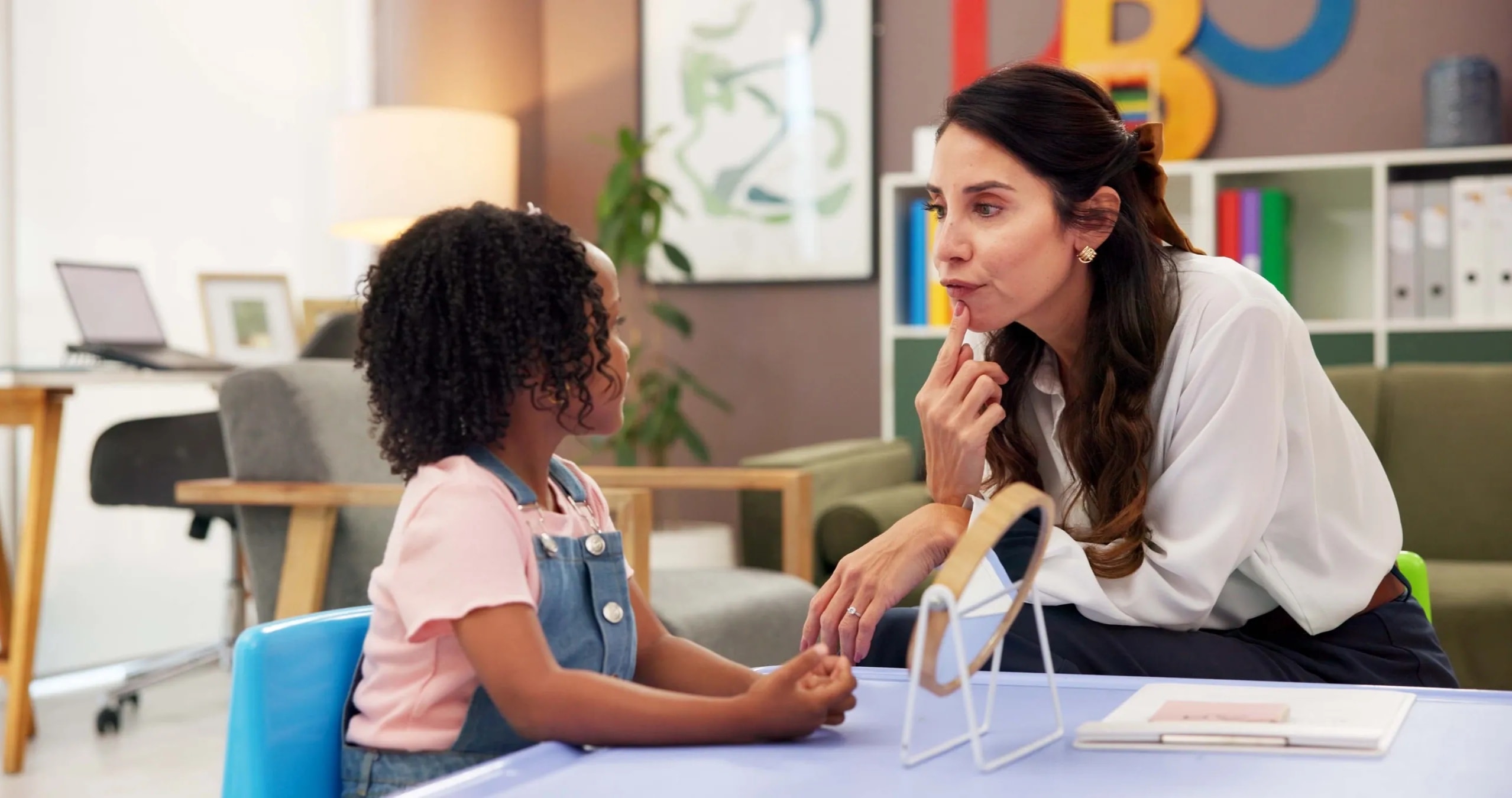 Speech language pathologist working with a child